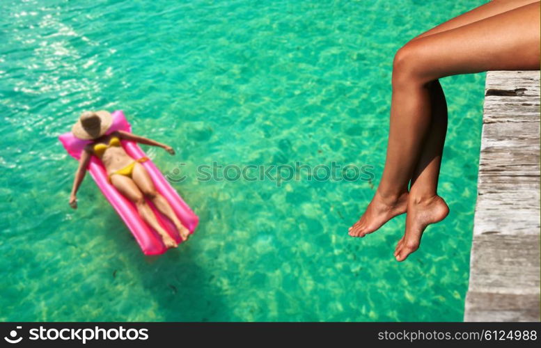 Woman relaxing at beach jetty