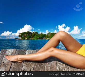 Woman relaxing at beach jetty