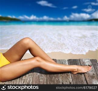 Woman relaxing at beach jetty