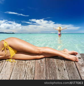 Woman relaxing at beach jetty&#x9;