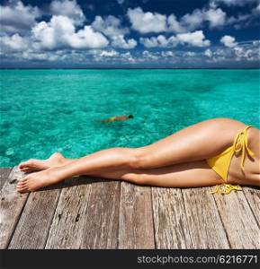 Woman relaxing at beach jetty&#x9;