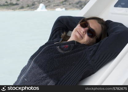 Woman relaxing at Lake Argentino, Santa Cruz Province, Patagonia, Argentina