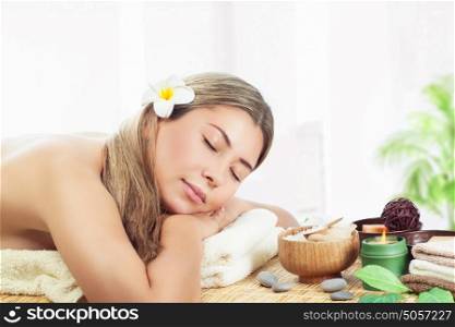 Woman relaxing at spa, peaceful female sleeping on massage table, closing eyes, health care and harmony of body, enjoying day in the beauty salon