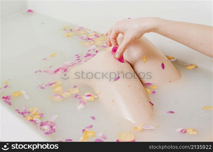 woman relaxing bath with flowers