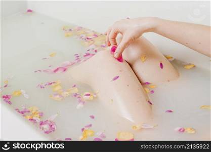 woman relaxing bath with flowers