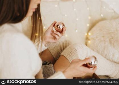 woman relaxing home holding decorative tree balls 2