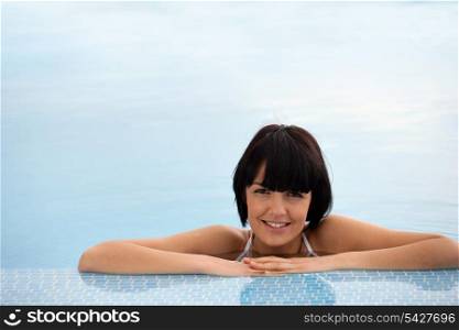 Woman relaxing in a swimming pool