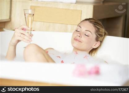 Woman Relaxing In Bath Drinking Champagne