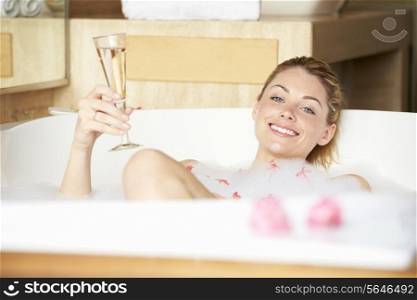 Woman Relaxing In Bath Drinking Champagne