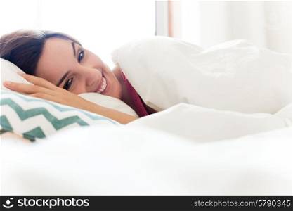 Woman relaxing in bed during the morning