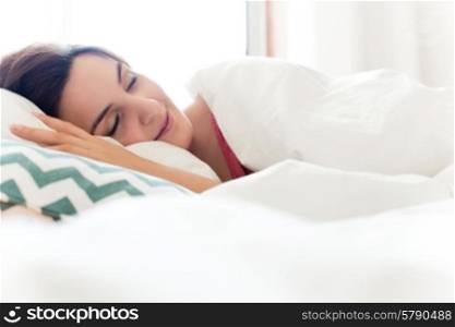 Woman relaxing in bed during the morning