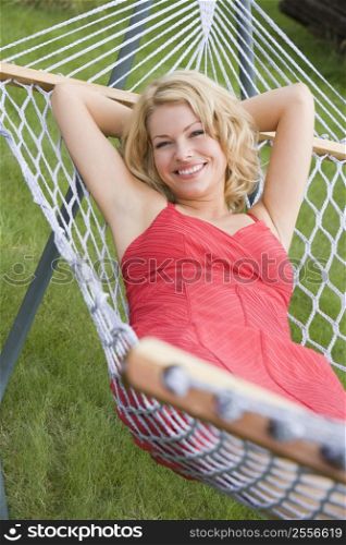 Woman relaxing in hammock smiling