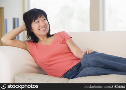 Woman relaxing in living room smiling