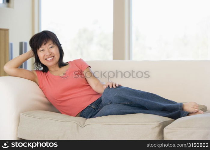 Woman relaxing in living room smiling