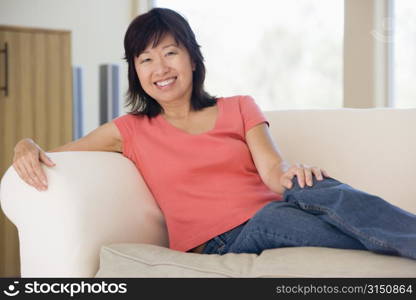 Woman relaxing in living room smiling