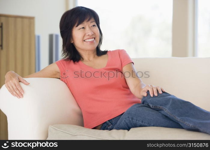 Woman relaxing in living room smiling