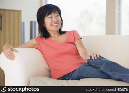 Woman relaxing in living room smiling