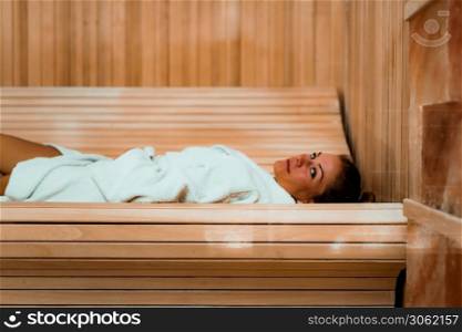 Woman Relaxing in Salt Room. Lying in Bathrobe on Bench and Enjoying .. Woman in Salt Cave or Salt Room.