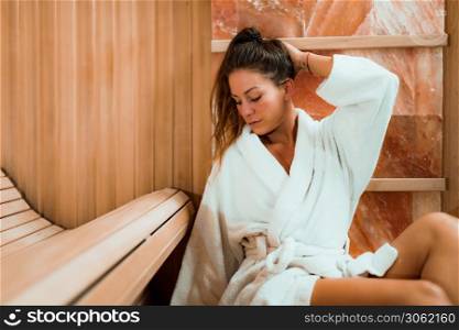 Woman Relaxing in Salt Room. Sitting in Bathrobe and Enjoying .. Woman in Salt Cave or Salt Room.