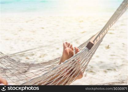 Woman relaxing in the hammock at the beach. Woman relaxing in the hammock at the beach.