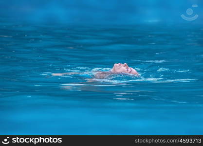 Woman relaxing in tropical ocean. Woman floating and relaxing in tropical ocean water