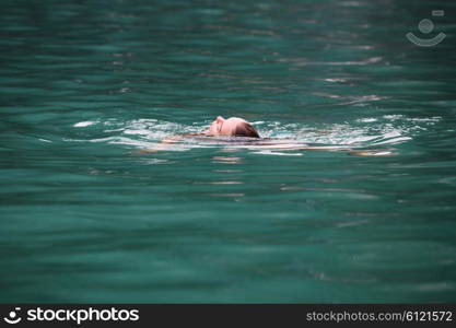 Woman relaxing in tropical ocean . Woman floating and relaxing in tropical ocean water