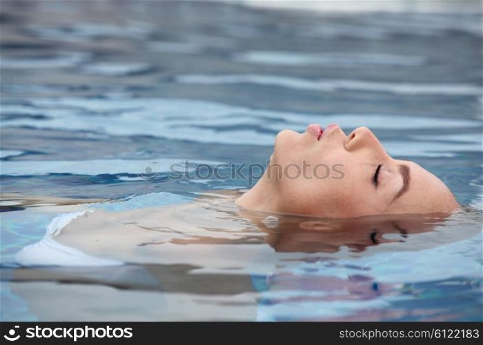 Woman relaxing in tropical ocean . Woman floating and relaxing in tropical ocean water