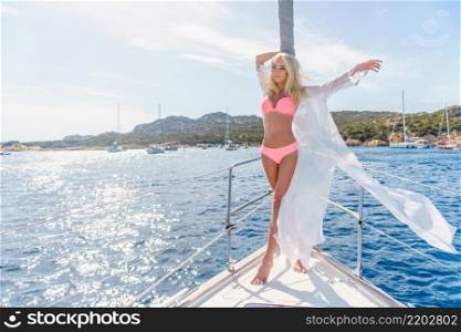 woman relaxing on a cruise boat wearing white tunic. woman relaxing on a cruise boat wearing tunic