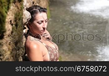 woman relaxing on a summer day by the waterfall