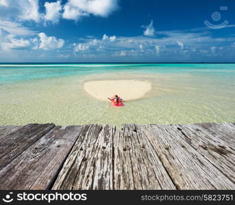 Woman relaxing on inflatable mattress at the beach