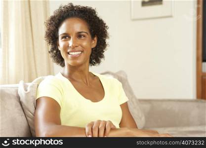 Woman Relaxing On Sofa At Home