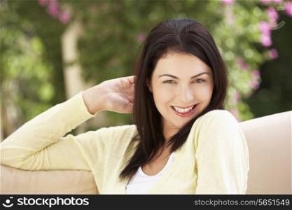 Woman Relaxing On Sofa At Home
