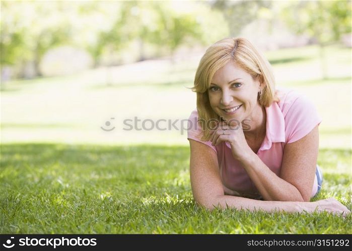 Woman relaxing outdoors smiling