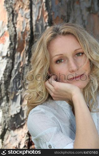 Woman relaxing under tree