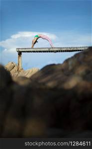 woman relaxing vacation playing yoga pose on beach pier