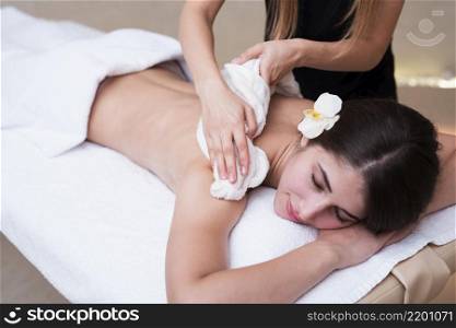 woman relaxing while getting spa treatment