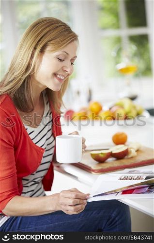 Woman Relaxing With Magazine At Home