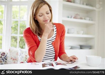 Woman Relaxing With Magazine At Home