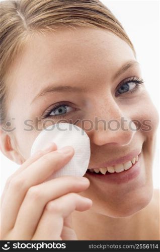 Woman removing makeup and smiling