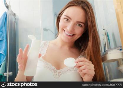 Woman removing makeup with cotton swab pad.. Woman removing makeup with cotton swab pad. Young girl taking care of skin. Skincare concept.