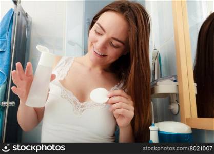 Woman removing makeup with cotton swab pad.. Woman removing makeup with cotton swab pad. Young girl taking care of skin. Skincare concept.