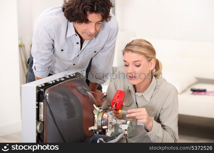 Woman repairing television