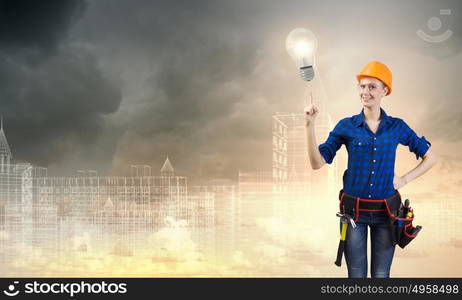 Woman repairman. Young woman handyman pointing at electrical bulb