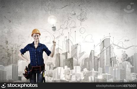 Woman repairman. Young woman handyman pointing at electrical bulb