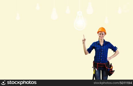 Woman repairman. Young woman handyman pointing at electrical bulb