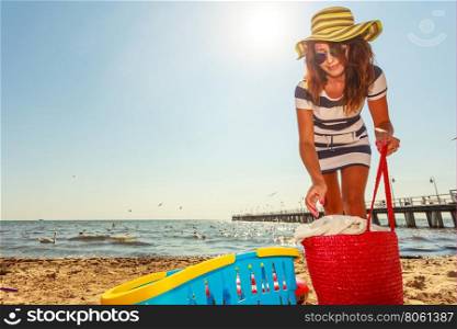 Woman restin on beach.. Relaxation and leisure. Attractive mid aged woman resting on beach. Female tourist relax near to water place on nature.