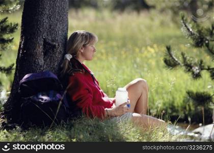 Woman Resting Against Tree