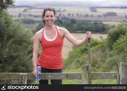 Woman Resting During Run In Countryside