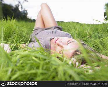 Woman resting in a green field