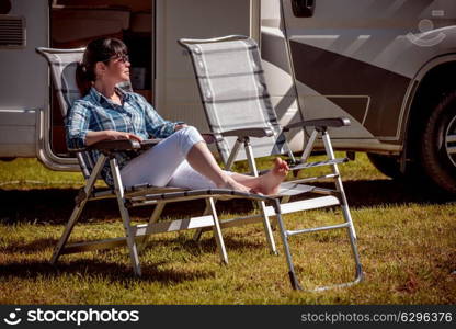 Woman resting near motorhomes in nature. Family vacation travel, holiday trip in motorhome RV, Caravan car Vacation.